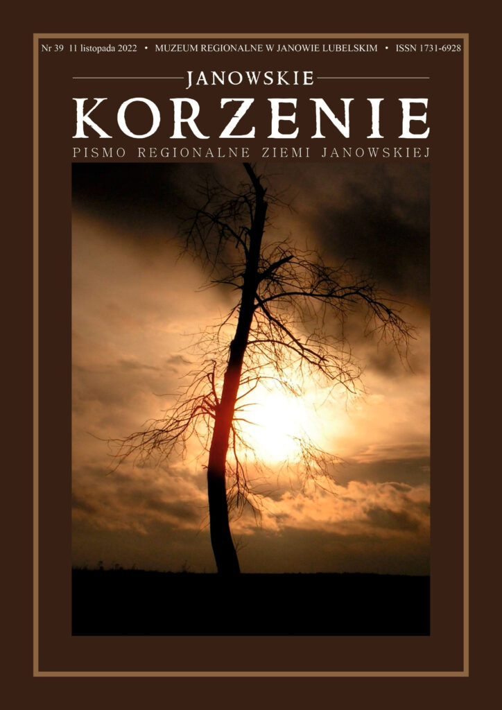 Sylwetka nagiego drzewa na tle zachodu słońca i pomarańczowo-brązowych chmur.